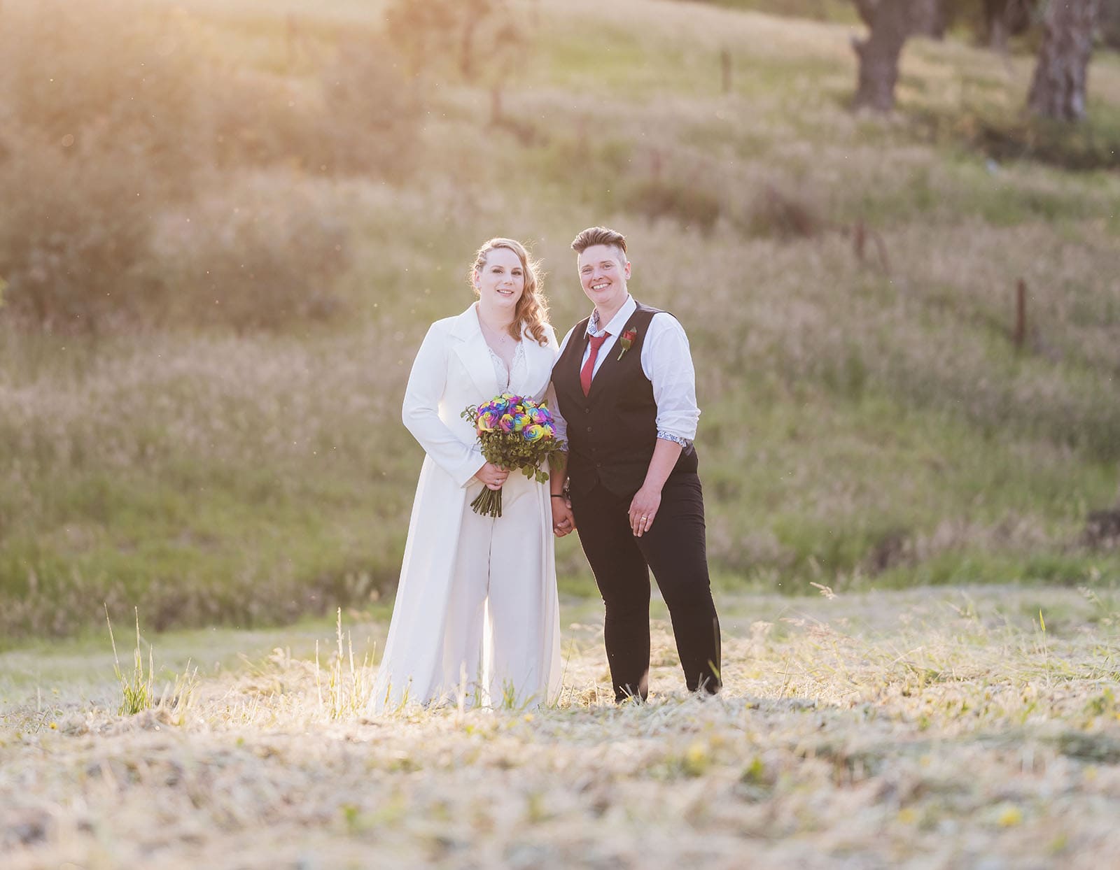 tiny house on the prairie wedding - kat & stacey 109 Bridal couple out standing in a field