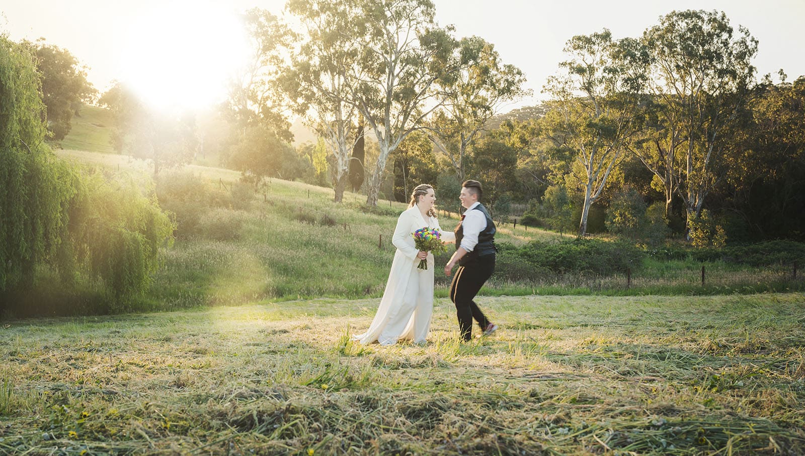 tiny house on the prairie wedding - kat & stacey 108 Bridal couple running on field
