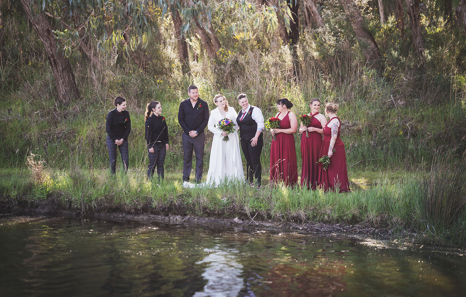 tiny house on the prairie wedding - kat & stacey 94 bridal party along edge of lake