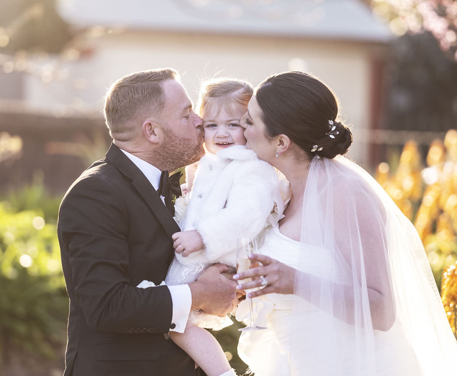 glenelg's partridge house wedding - emma & steven 151 Bride and groom kiss the little one