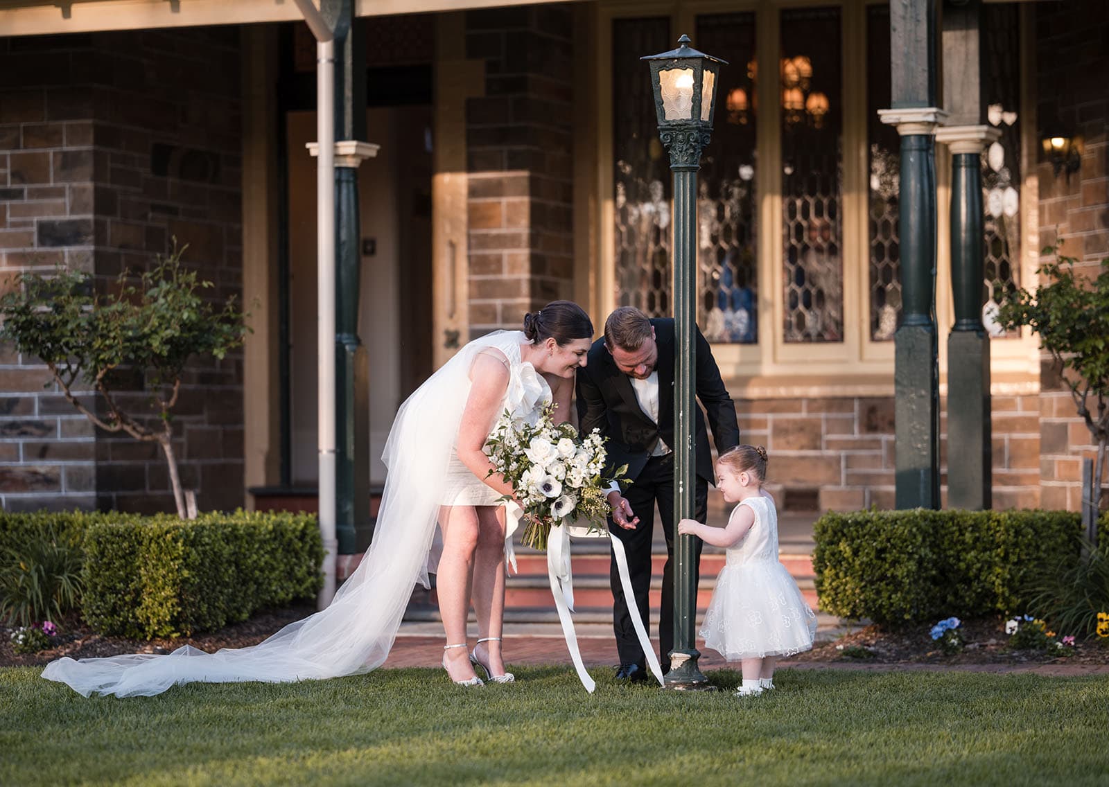 glenelg's partridge house wedding - emma & steven 154 Bride and groom talking to little girl