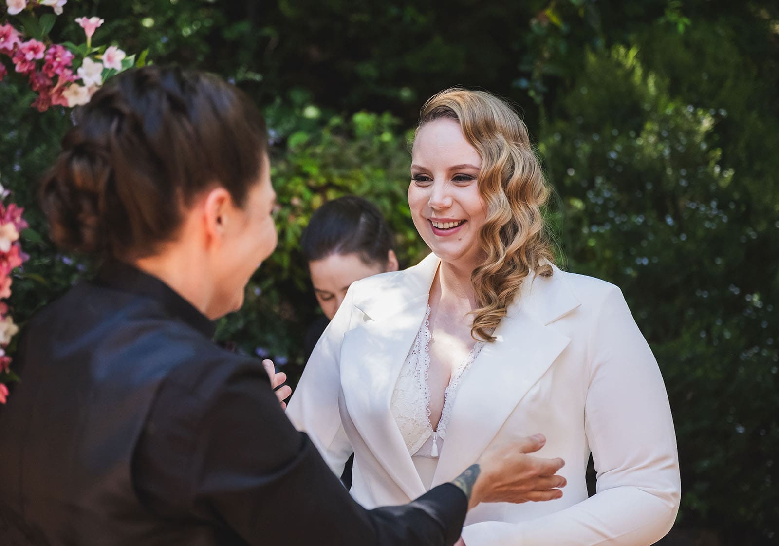 tiny house on the prairie wedding - kat & stacey 73 Bride grinning at bridesmaid