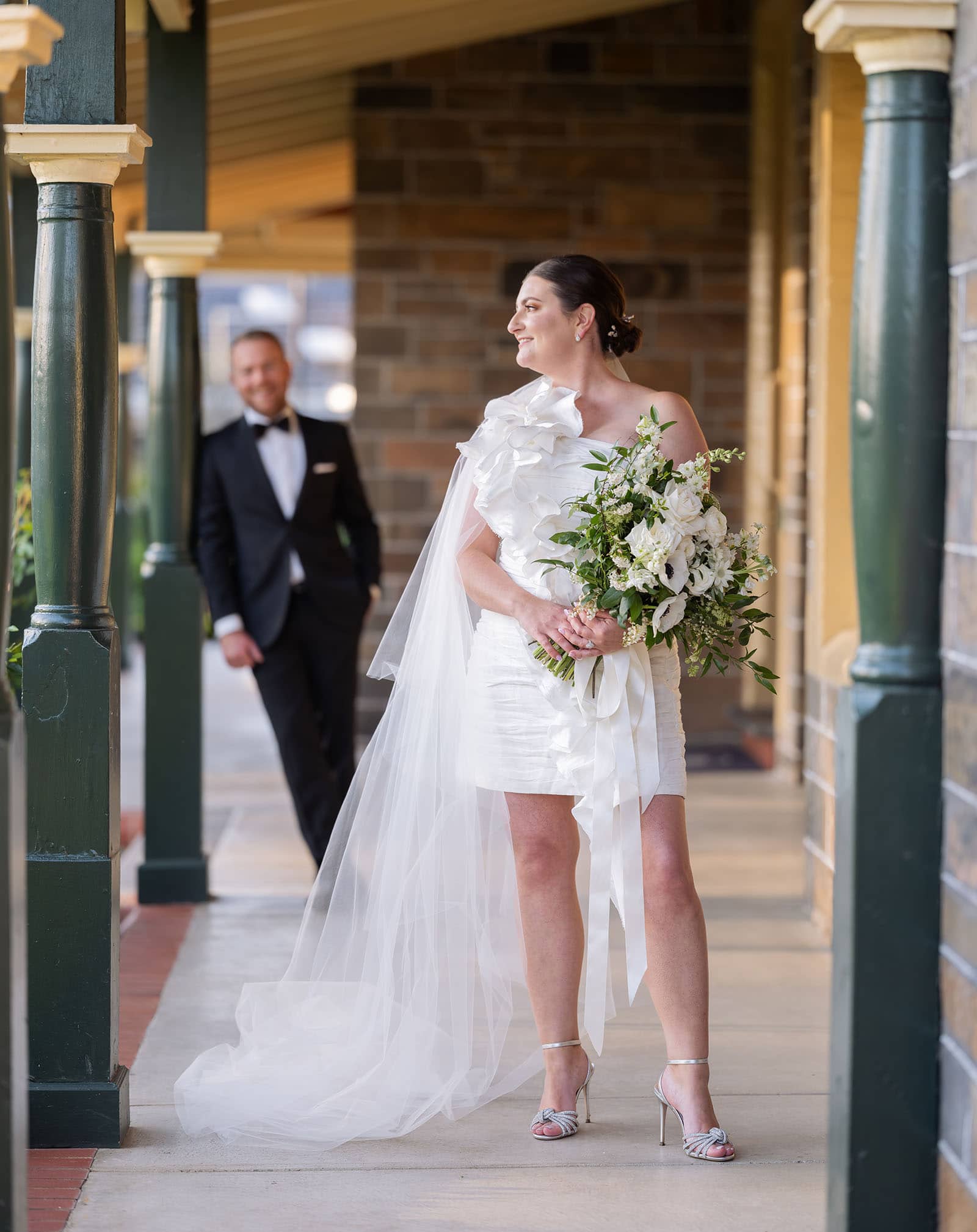 glenelg's partridge house wedding - emma & steven 155 Bride standing on porch with groom in background