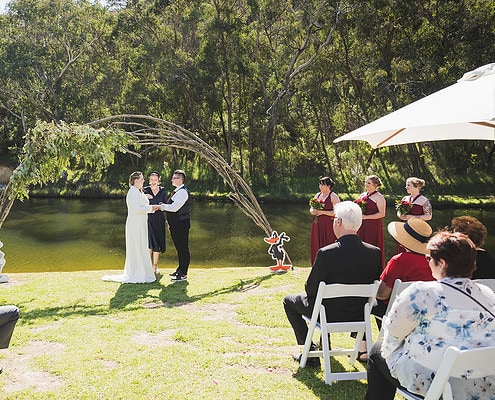 brides holding hands during ceremony
