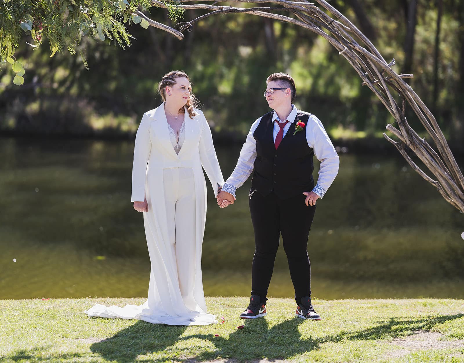 tiny house on the prairie wedding - kat & stacey 80 Brides standing under natural arbour