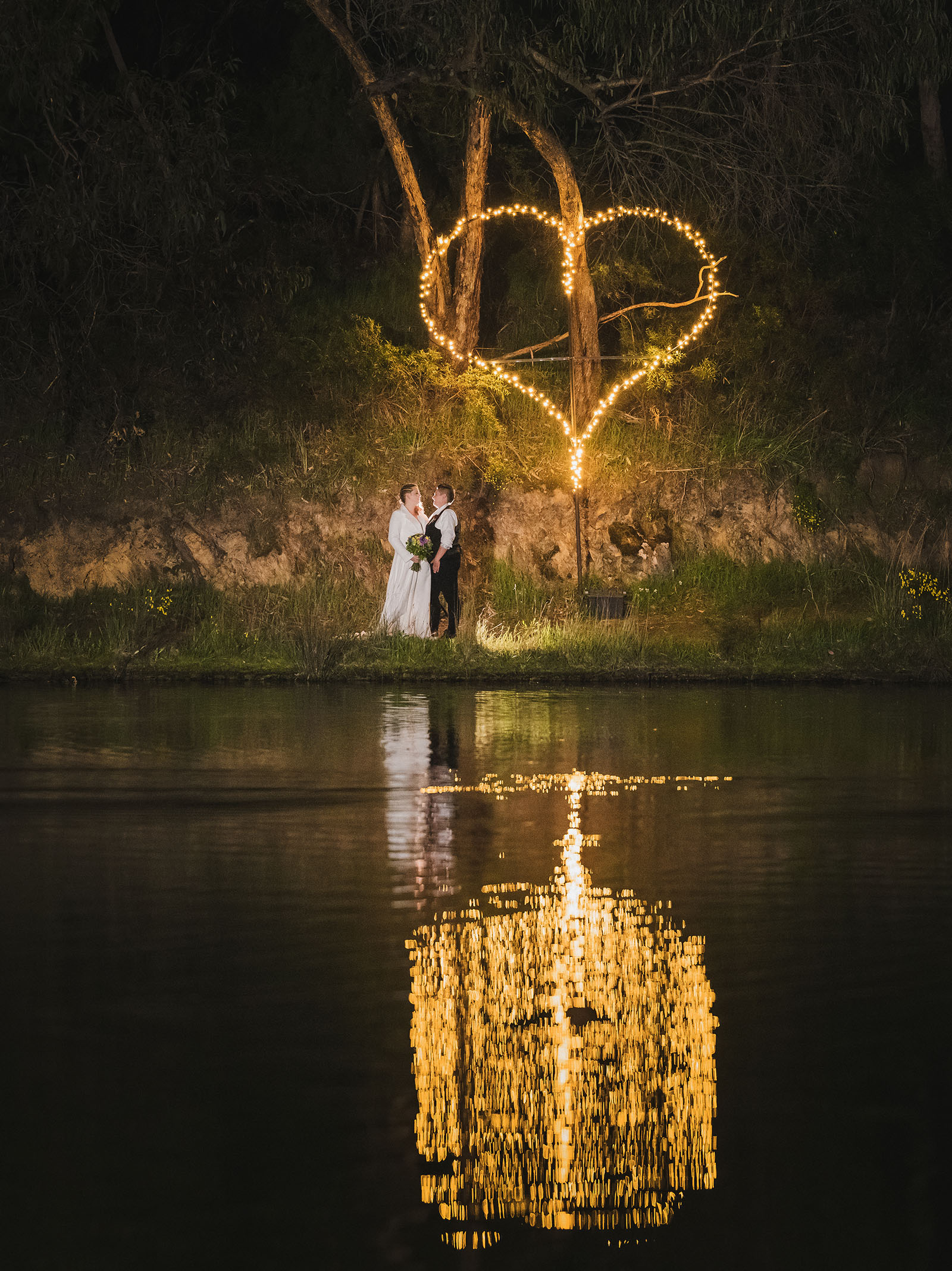 tiny house on the prairie wedding - kat & stacey 119 Brides under lit up love heart