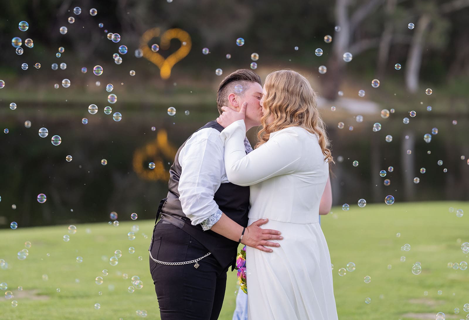 tiny house on the prairie wedding - kat & stacey 116 Kiss under the bubble machine