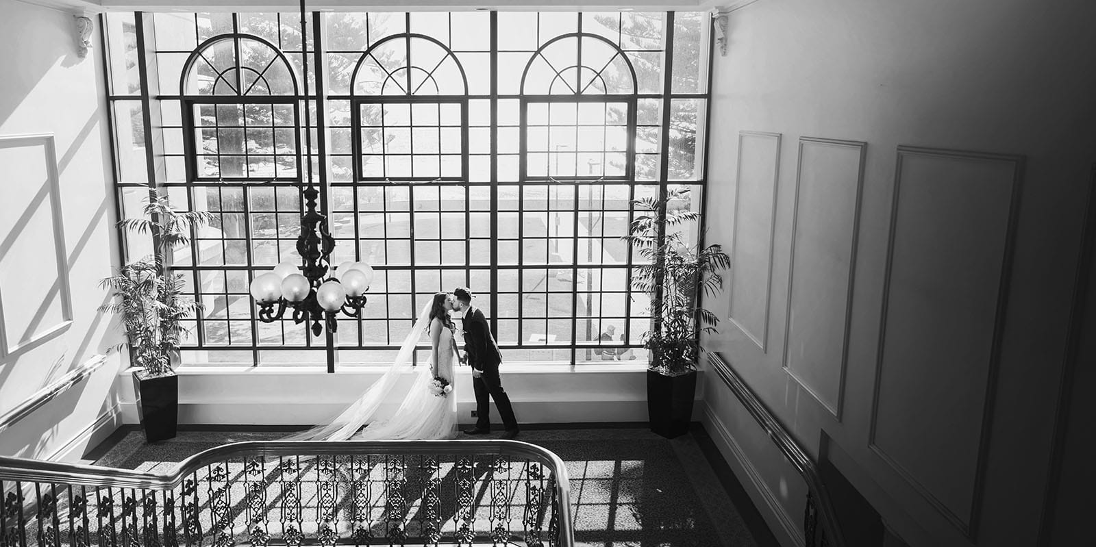 stamford grand wedding - jess & tim 70 Bridal couple in front of large window in the Grand
