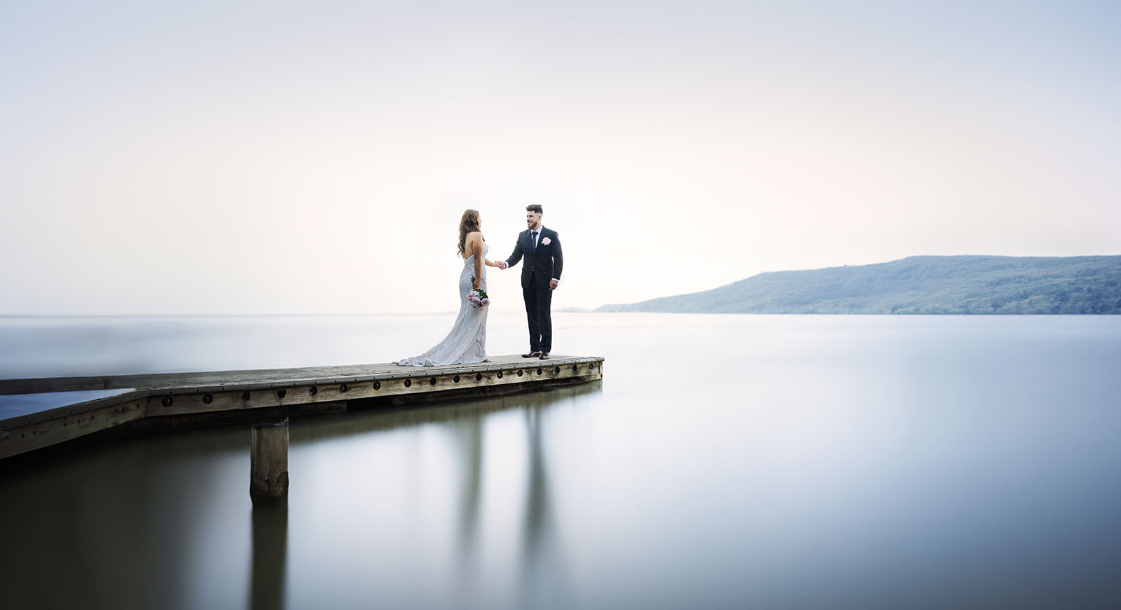 stamford grand wedding - jess & tim 84 Bride and groom at end of short pier