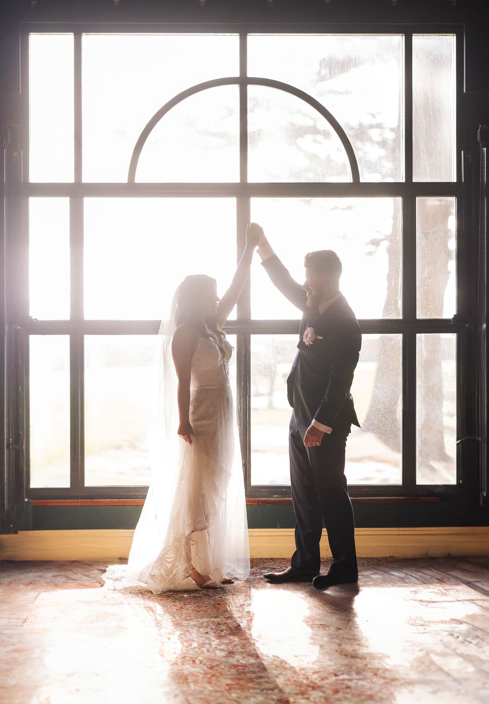 stamford grand wedding - jess & tim 73 bride and groom dancing in front of window