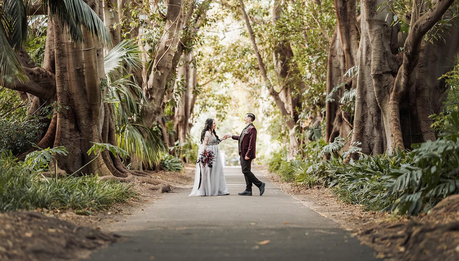 palm house gardens wedding - ayla & drew 166 Bride and groom dancing in tree avenue