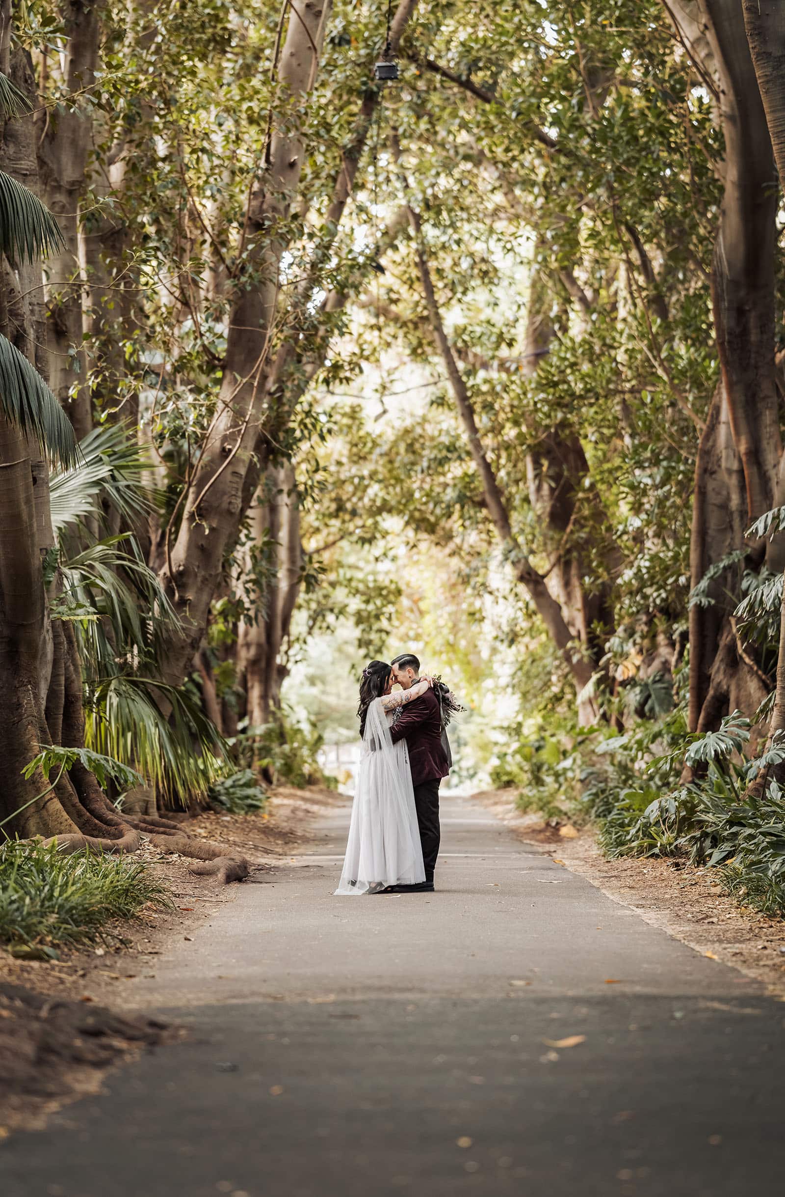 palm house gardens wedding - ayla & drew 167 Bride and groom embrace under the trees