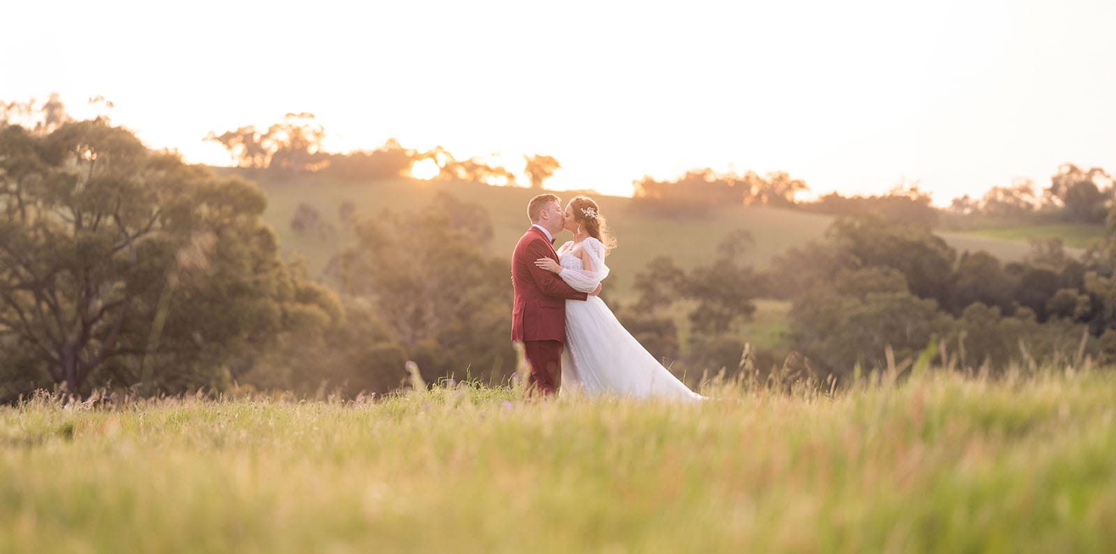 templewood house wedding - michelle & andrew 40 Bride and groom kiss under sunset