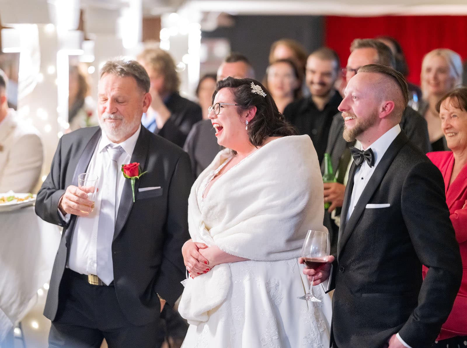 botanic gardens palm house wedding - kelly & david 130 Bride laughing during a wedding speech beside the groom and an older man holding a drink