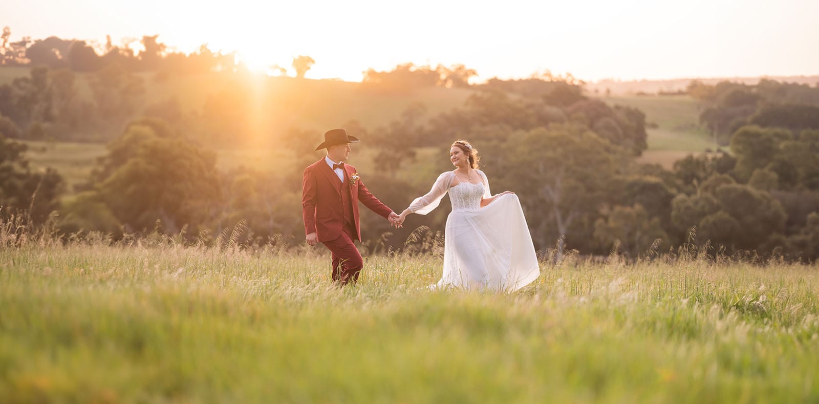 templewood house wedding - michelle & andrew 38 Bride leading groom through long grass