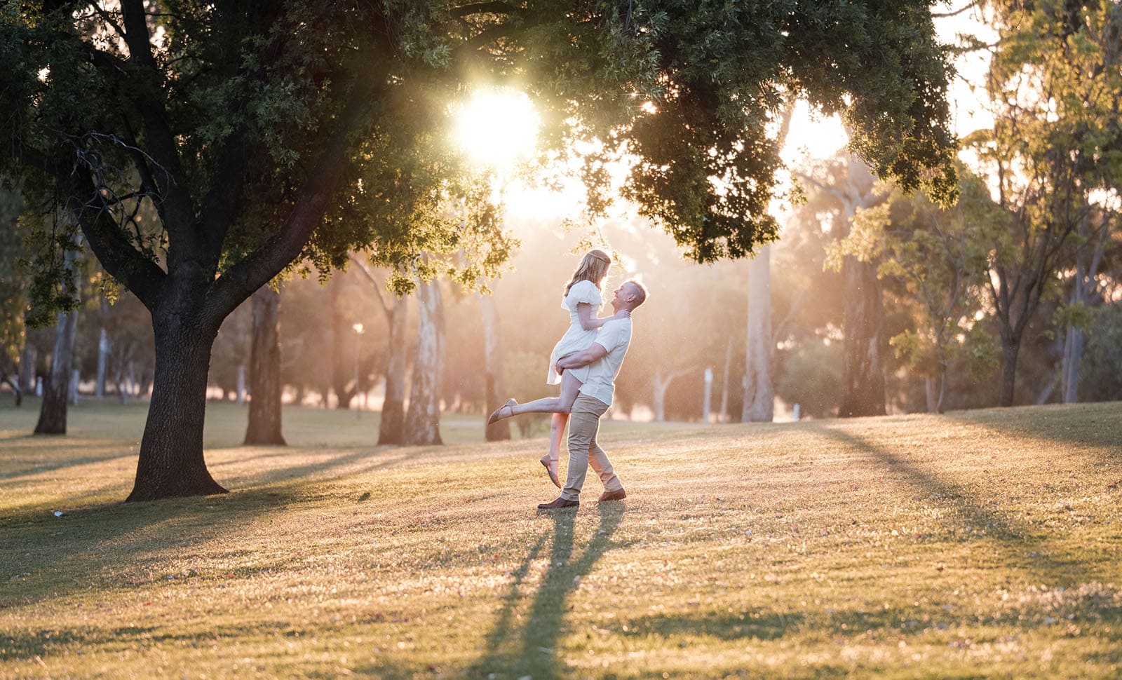 adelaide parklands engagement shoot - stacey & jacob 205 Couple lift under sunset