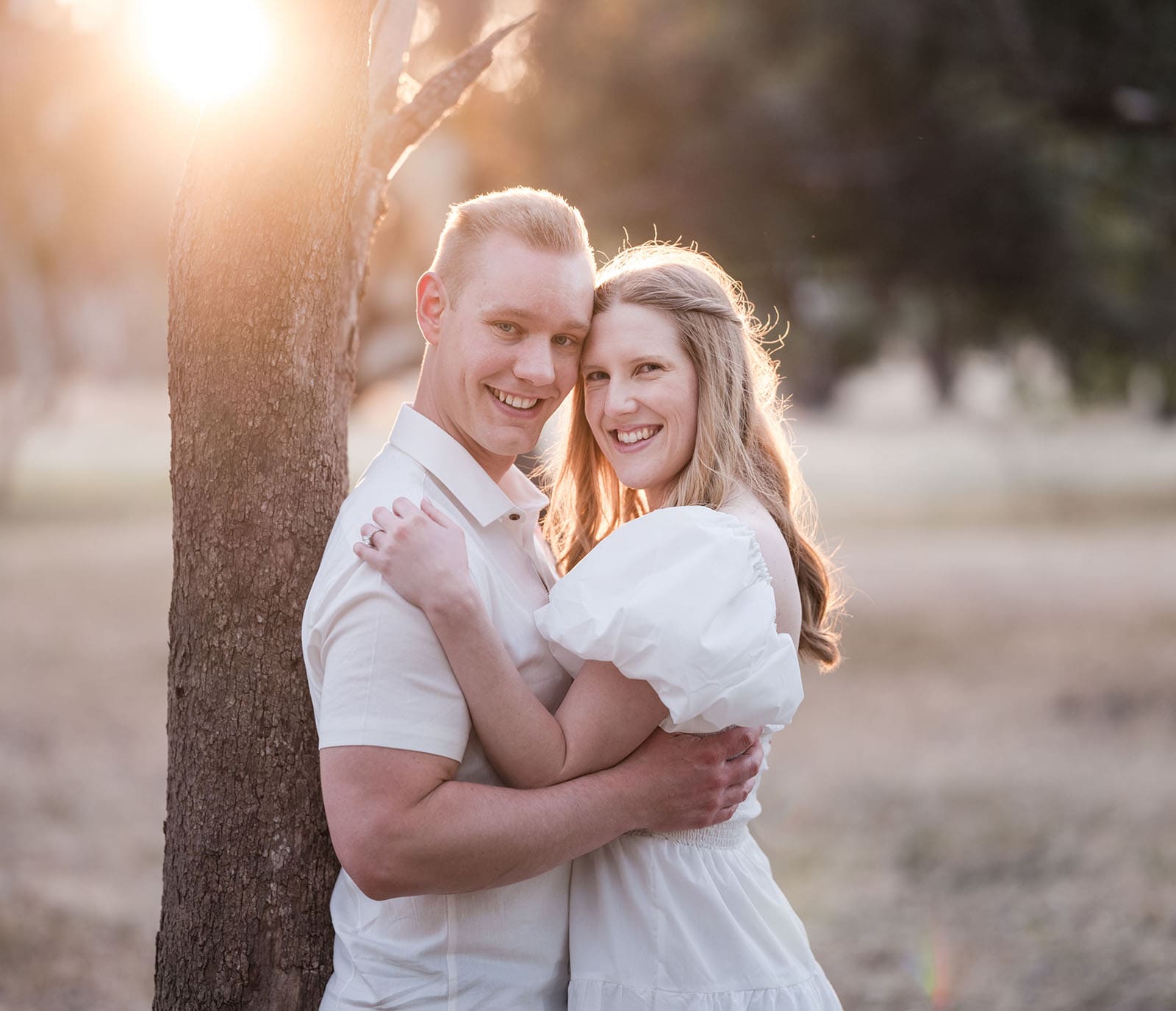 adelaide parklands engagement shoot - stacey & jacob 203 Couple looking at camera with sunlight in rear
