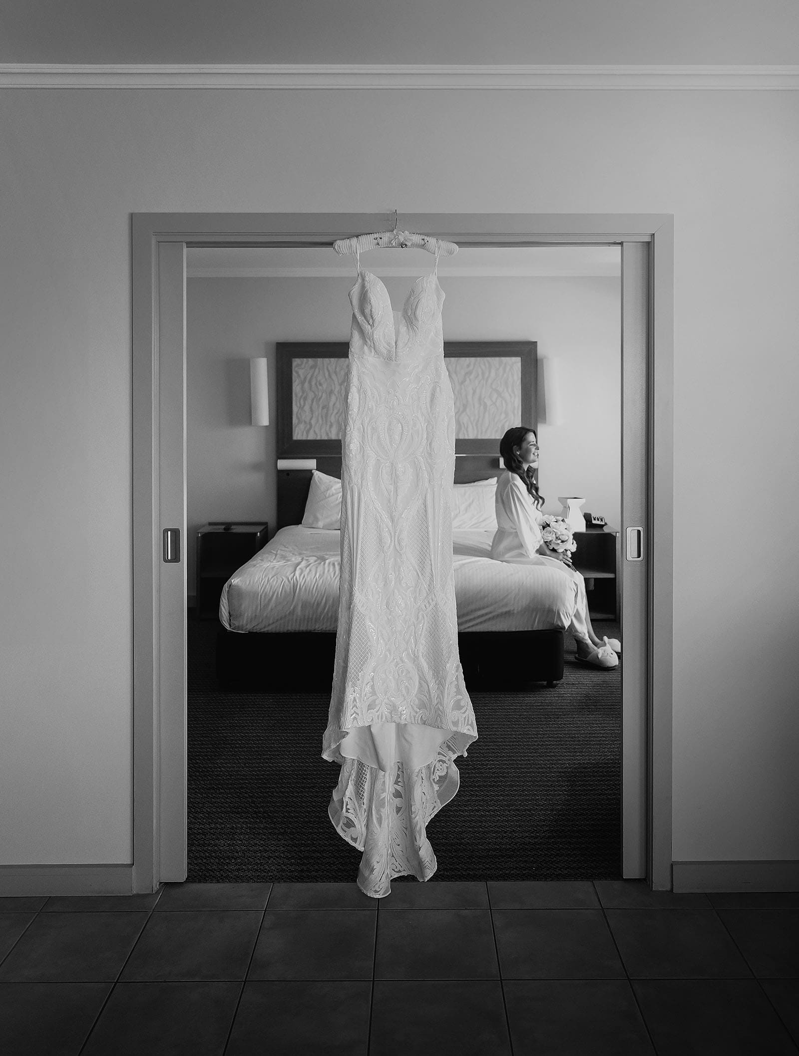 stamford grand wedding - jess & tim 52 Dress hanging in door frame