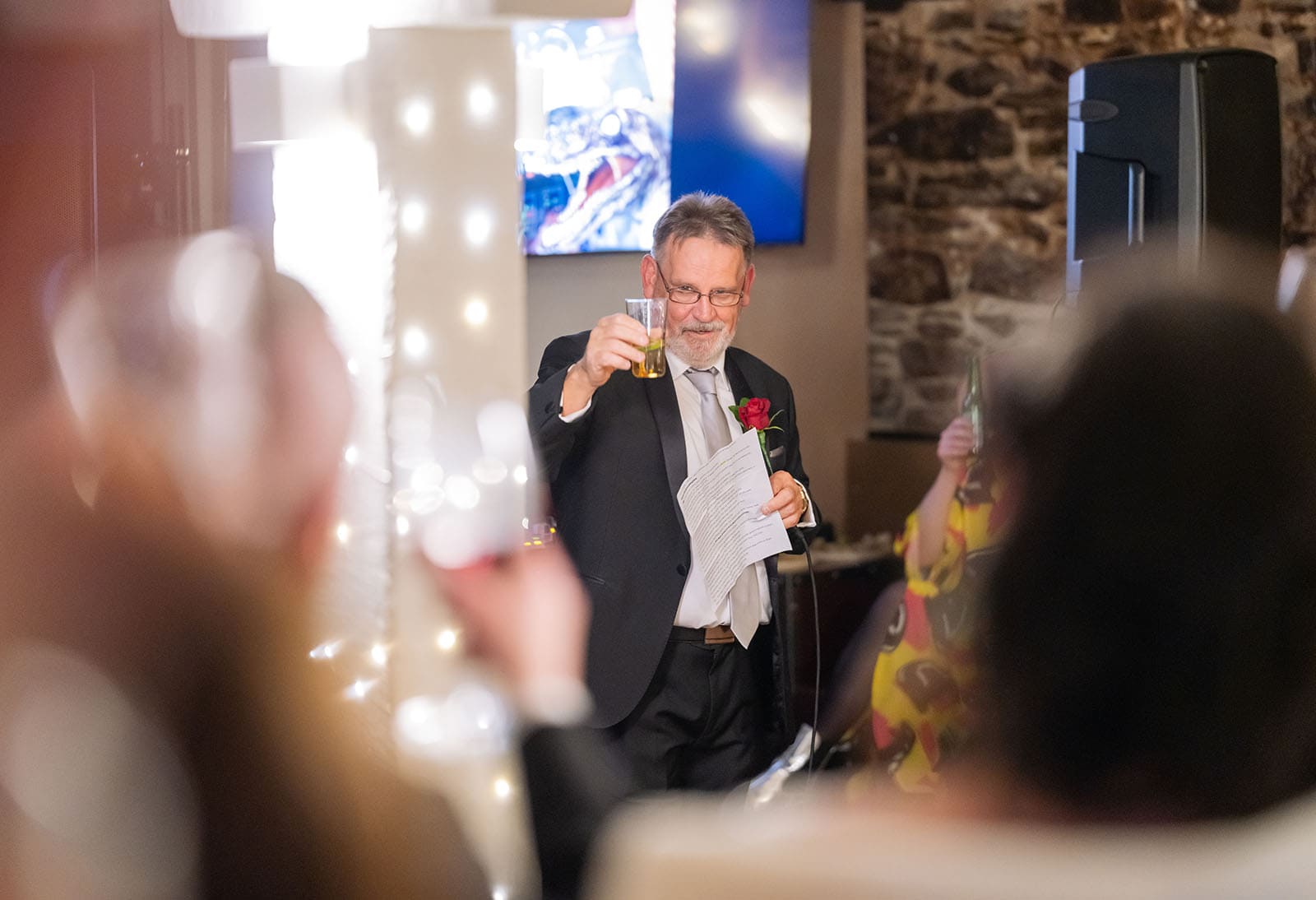 botanic gardens palm house wedding - kelly & david 129 Father of the bride raising a glass while holding speech notes at Kelly and David’s wedding reception