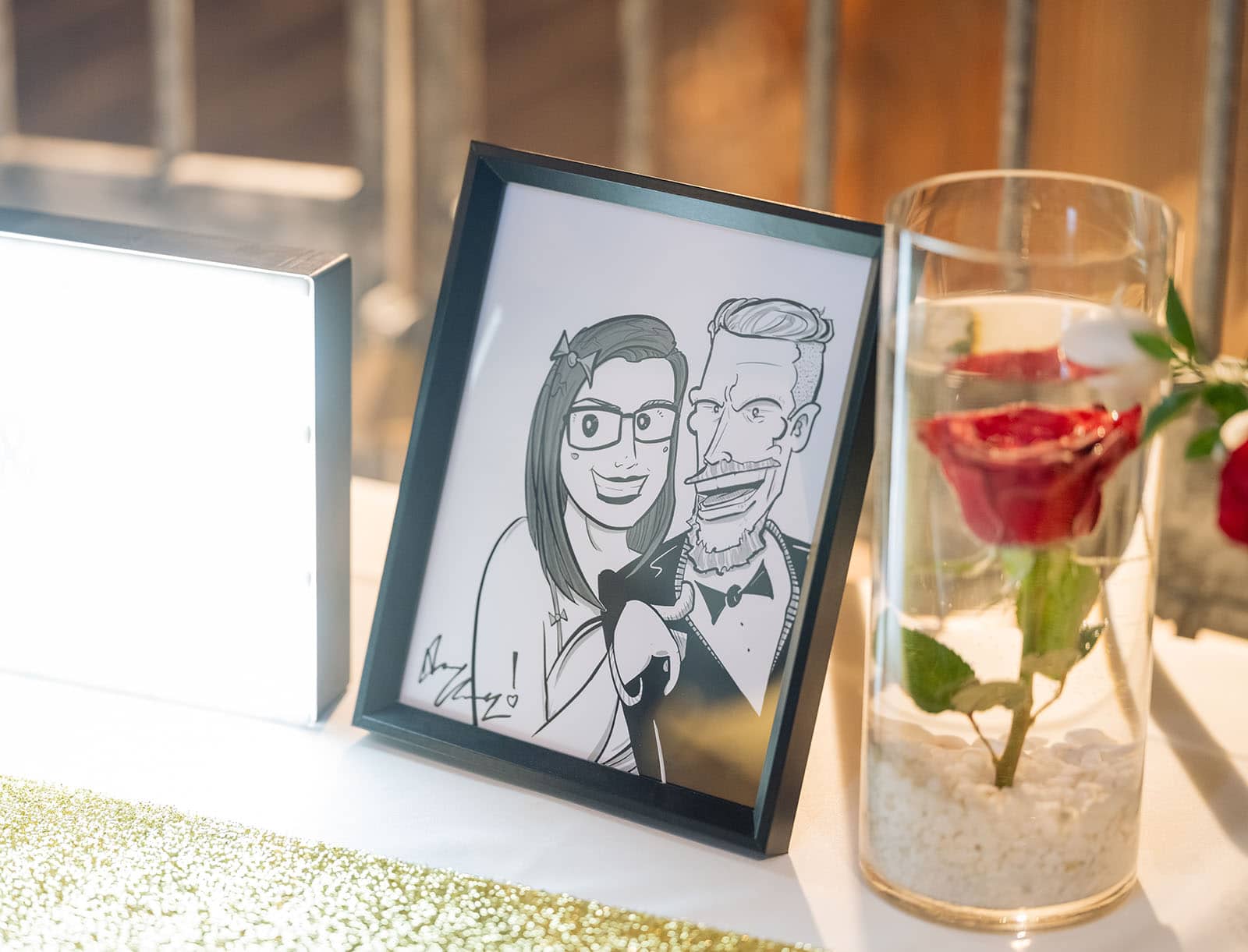 botanic gardens palm house wedding - kelly & david 123 Framed cartoon sketch of the wedding couple beside a glass vase holding a red rose