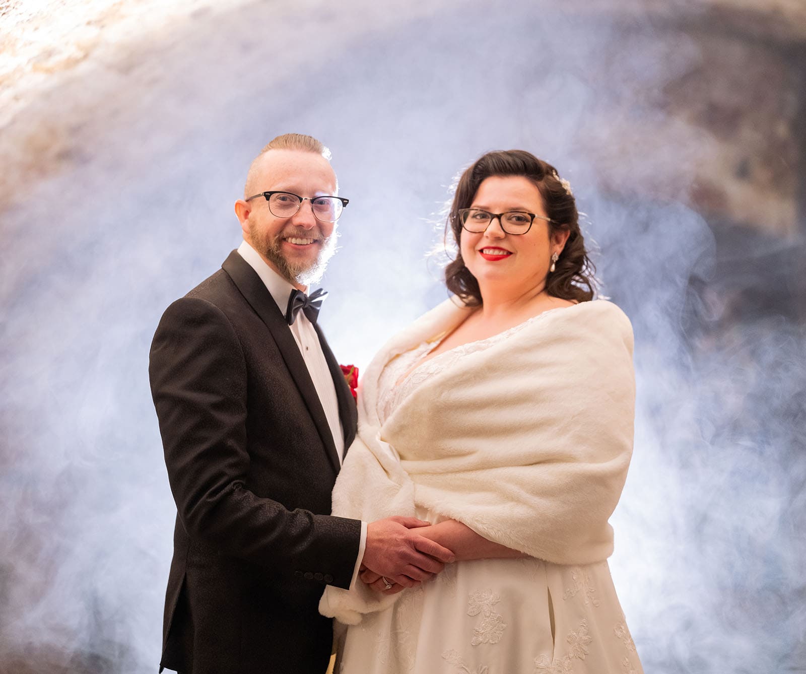 botanic gardens palm house wedding - kelly & david 121 Kelly and David smiling together in formal wedding attire amid a softly backlit smoky backdrop