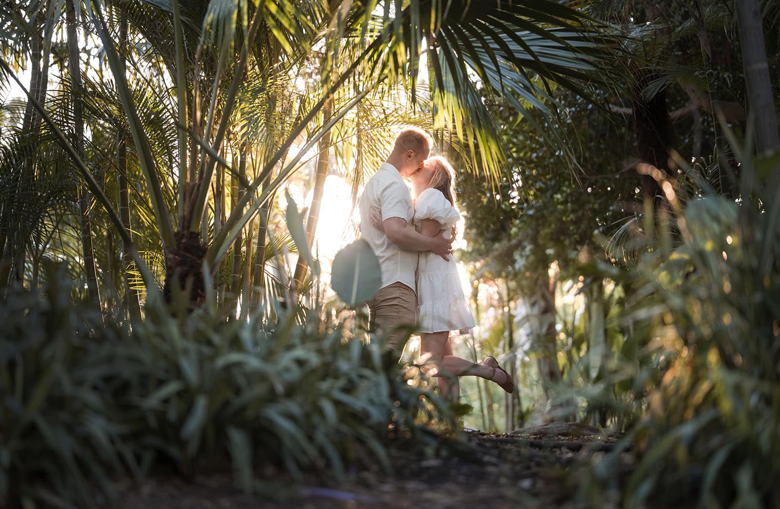 adelaide parklands engagement shoot - stacey & jacob 199 Kiss in amongst the plant foliage