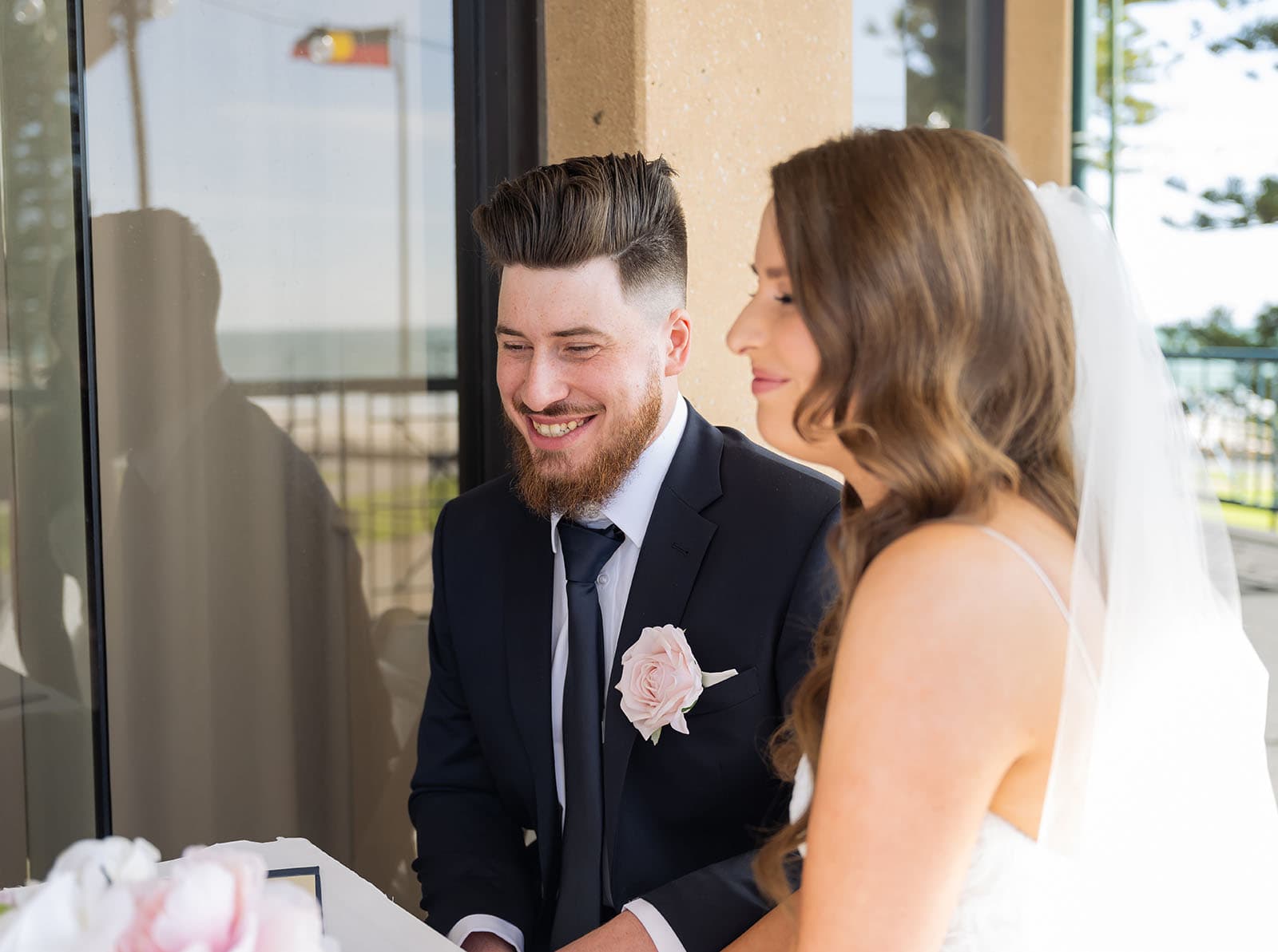 stamford grand wedding - jess & tim 68 Laughing groom siging certificate