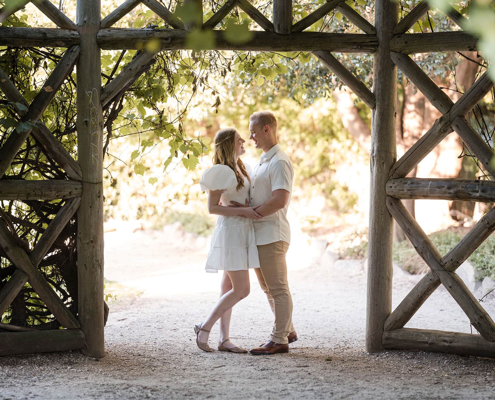 adelaide parklands engagement shoot - stacey & jacob 196 Romantic embrace in garden archway