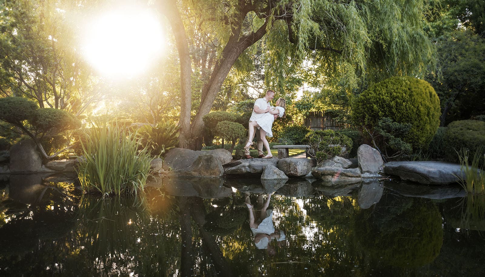 adelaide parklands engagement shoot - stacey & jacob 193 Sunlight filtering through garden leaves onto couple