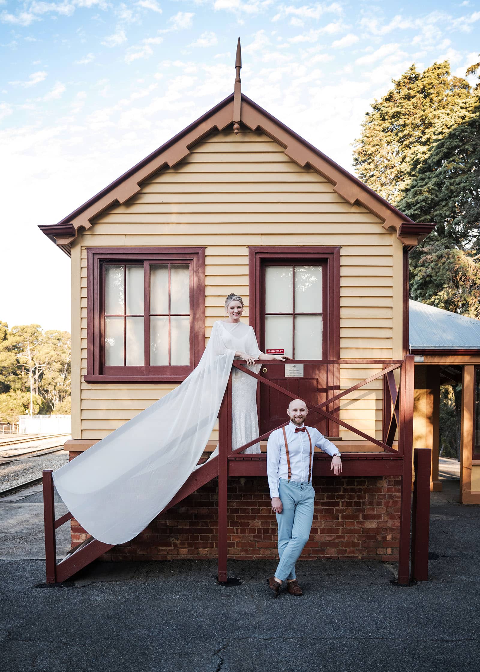 belair national park engagement shoot - lindsey & jaden 10 Bride and groom posing by historic train station.