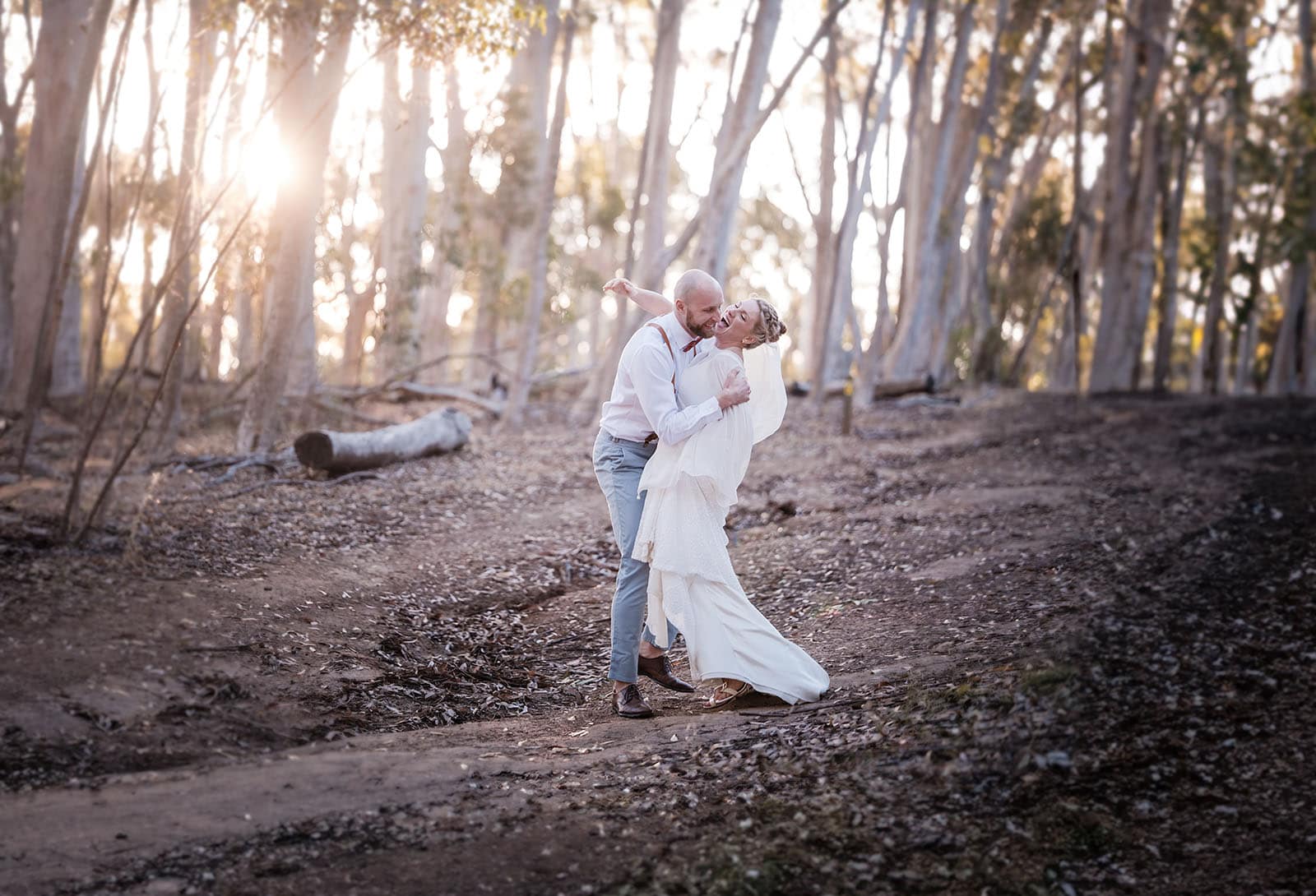 belair national park engagement shoot - lindsey & jaden 23 Couple embracing in sunlit forest wedding shoot