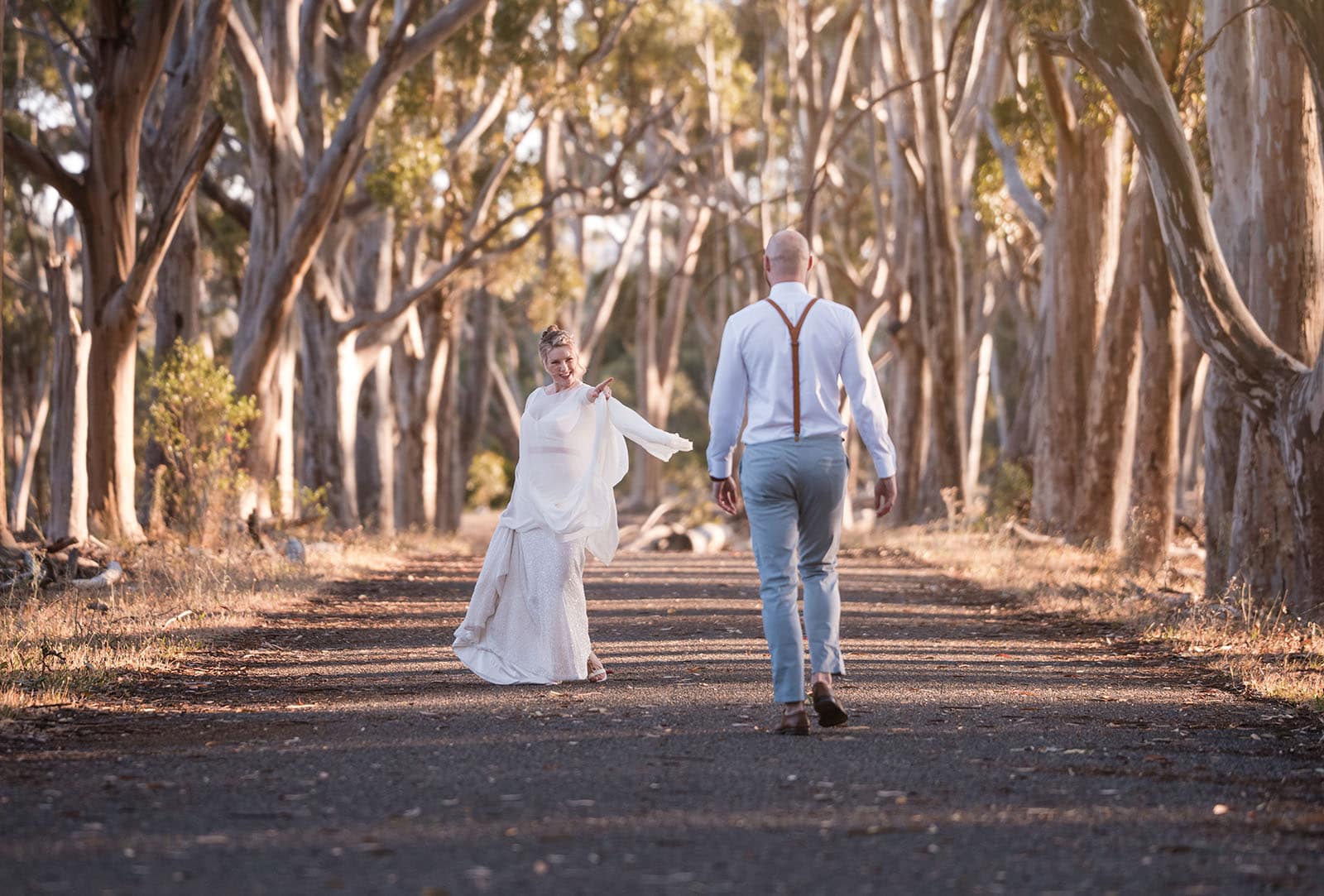 belair national park engagement shoot - lindsey & jaden 25 Couple walking hand-in-hand in forest pathway