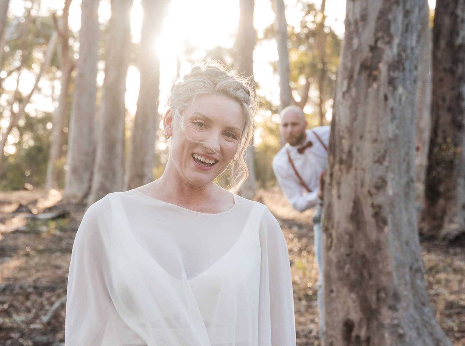belair national park engagement shoot - lindsey & jaden 21 Bride smiling in forest sunset, groom in background