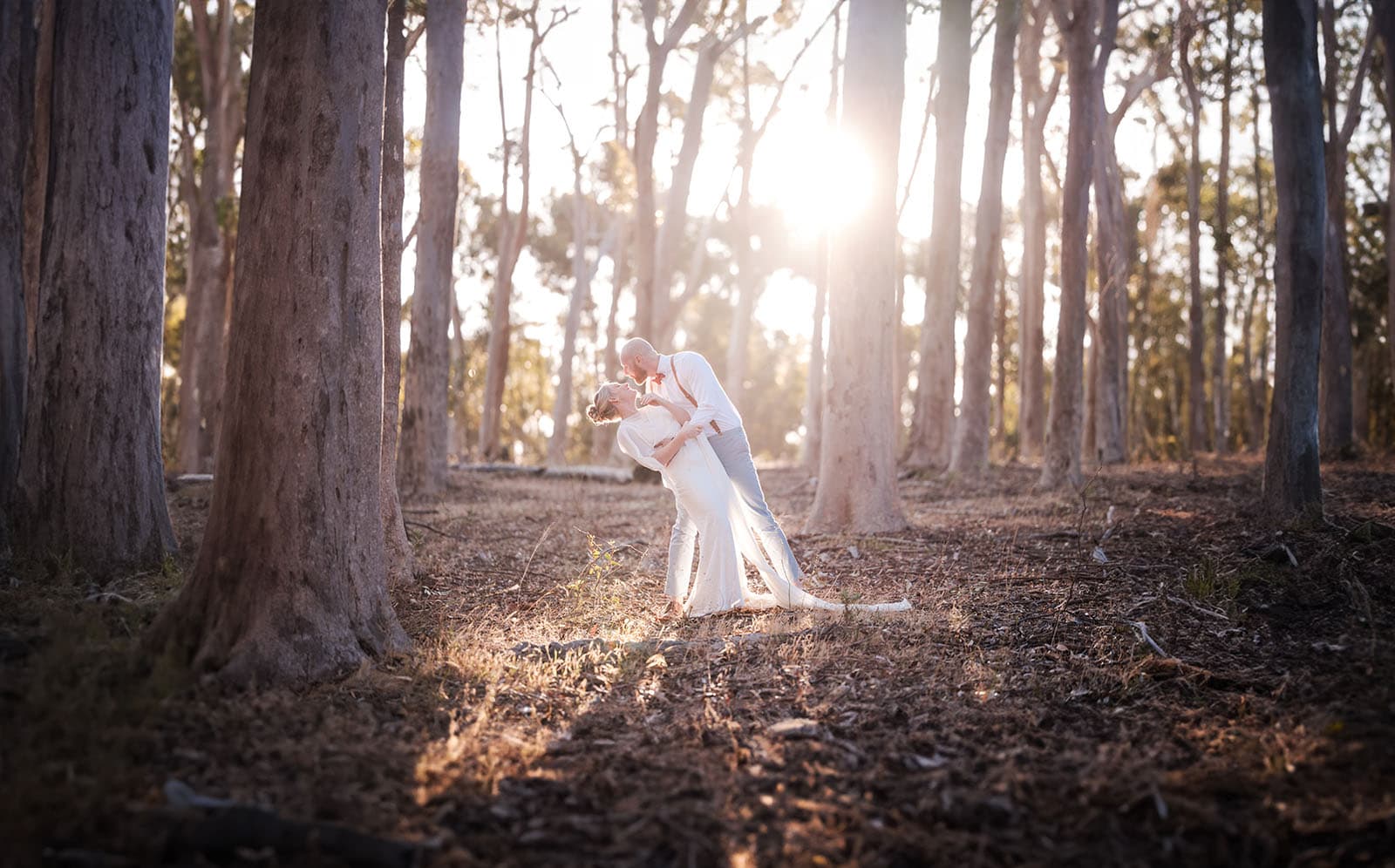 belair national park engagement shoot - lindsey & jaden 13 Couple kissing in sunset-lit forest