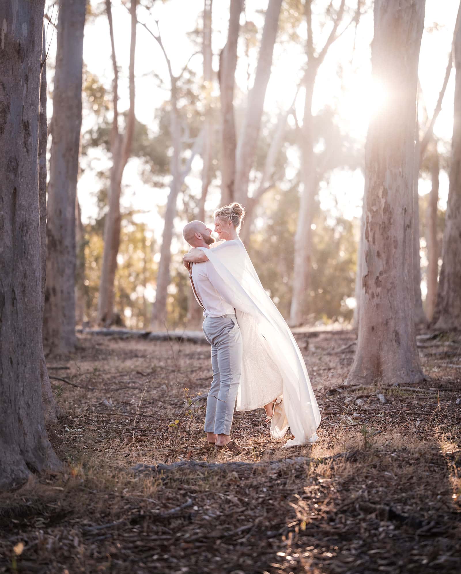 belair national park engagement shoot - lindsey & jaden 14 Couple embracing in forest at sunset