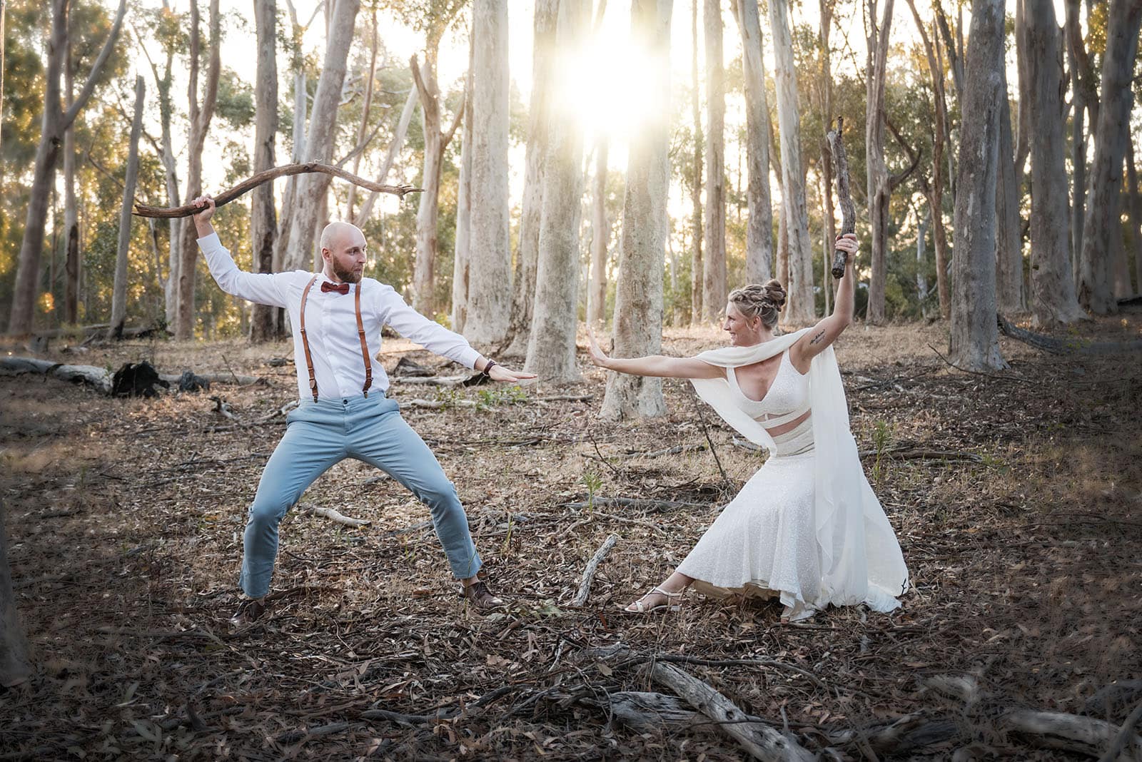 belair national park engagement shoot - lindsey & jaden 17 Couple in whimsical forest duel pose with sticks