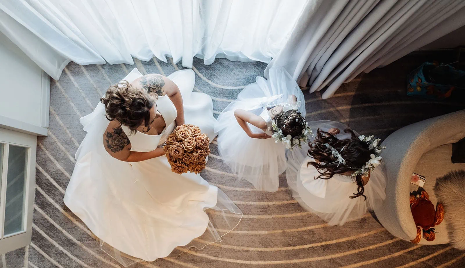 botanic gardens, araucaria avenue wedding - jade & hazim 27 Two brides in elegant white dresses holding bouquets, captured in serene wedding day preparation.