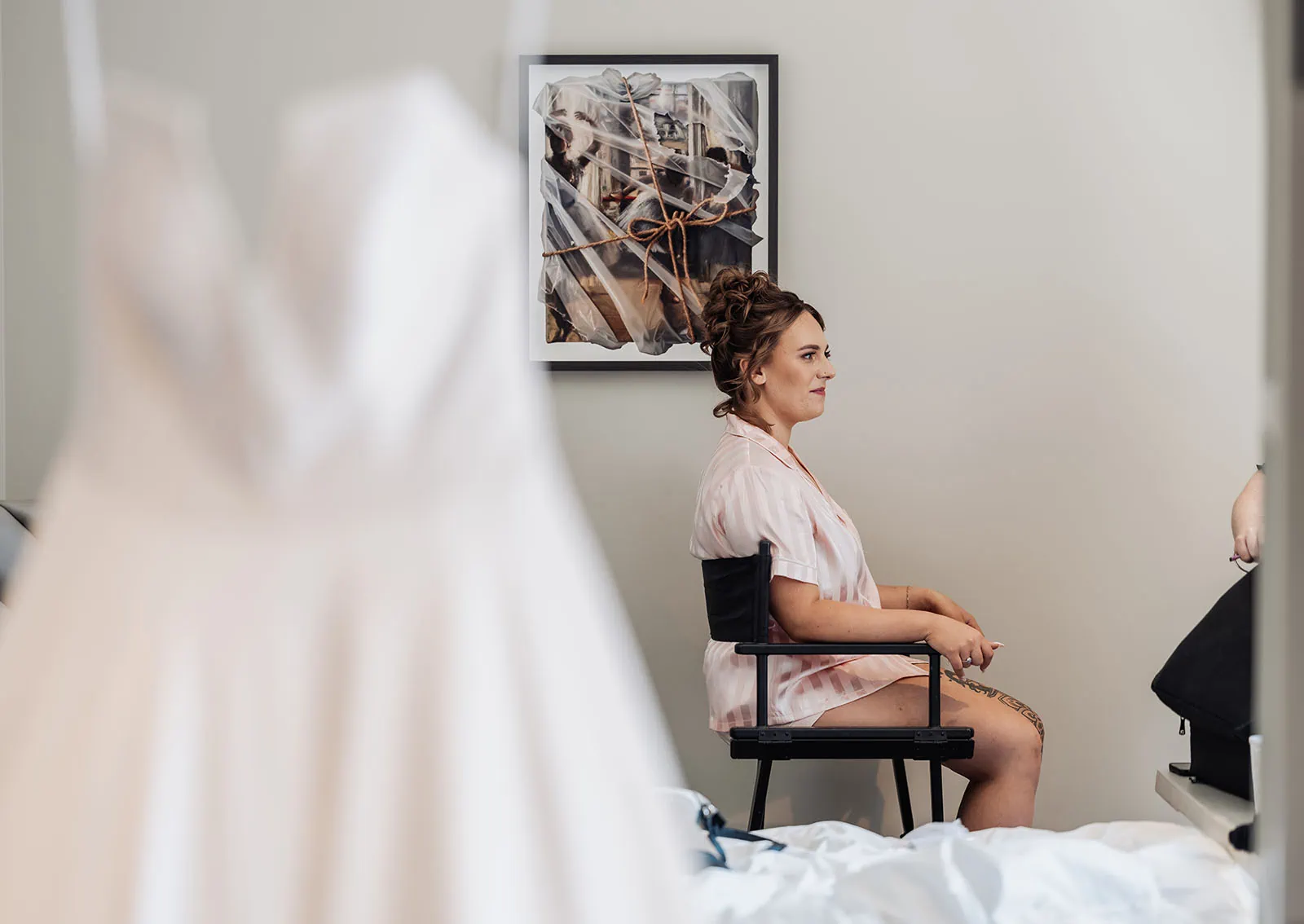 botanic gardens, araucaria avenue wedding - jade & hazim 16 Bride smiling in serene room with bridal gown during wedding preparations.