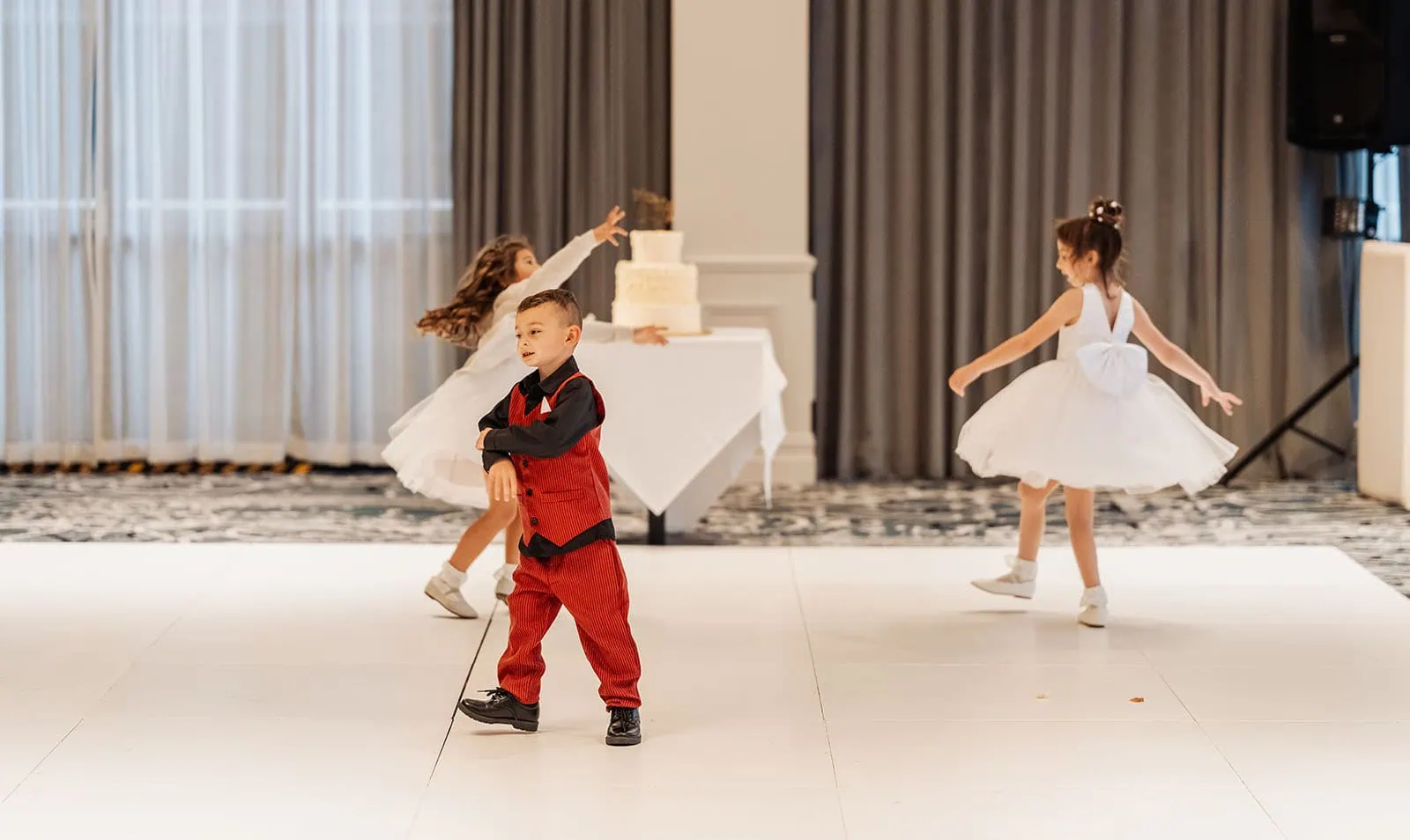 botanic gardens, araucaria avenue wedding - jade & hazim 65 Children joyfully dancing at an elegant wedding reception.
