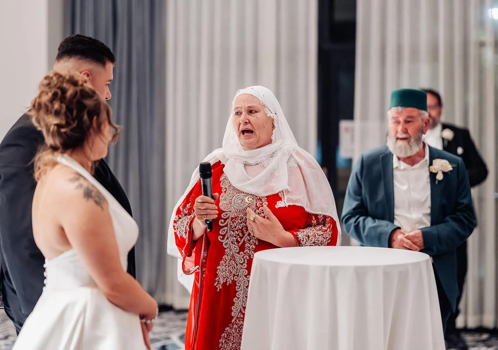 botanic gardens, araucaria avenue wedding - jade & hazim 76 Elderly woman delivering heartfelt speech at multicultural wedding ceremony.