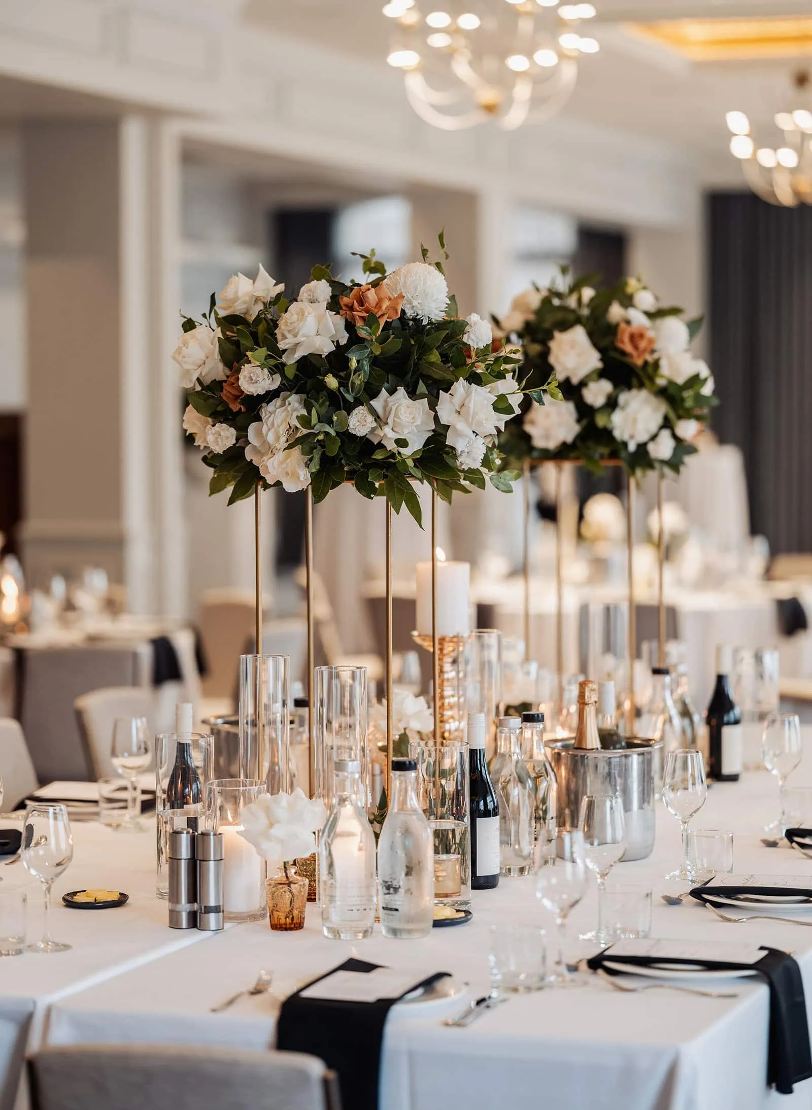 botanic gardens, araucaria avenue wedding - jade & hazim 77 Elegant dining setup with floral centerpiece and candles for formal event.