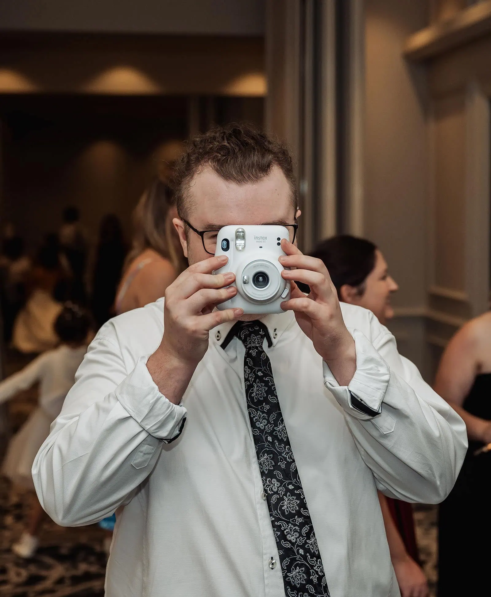botanic gardens, araucaria avenue wedding - jade & hazim 64 Photographer capturing a formal event with an Instax instant camera.