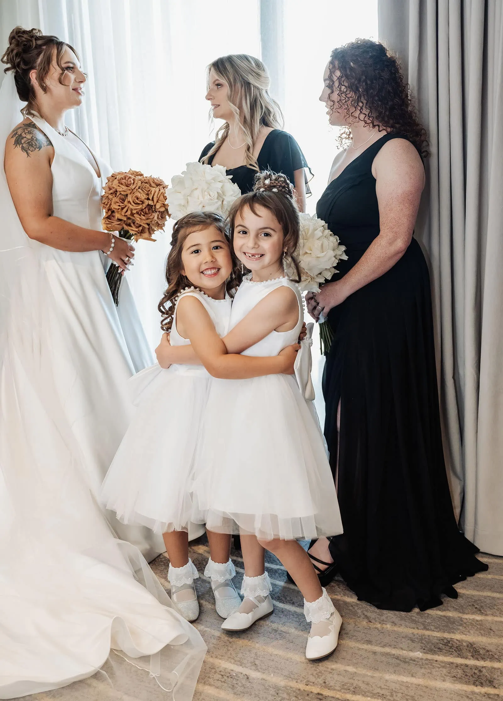 botanic gardens, araucaria avenue wedding - jade & hazim 26 Flower girls and bridesmaids in elegant attire at a wedding celebration.