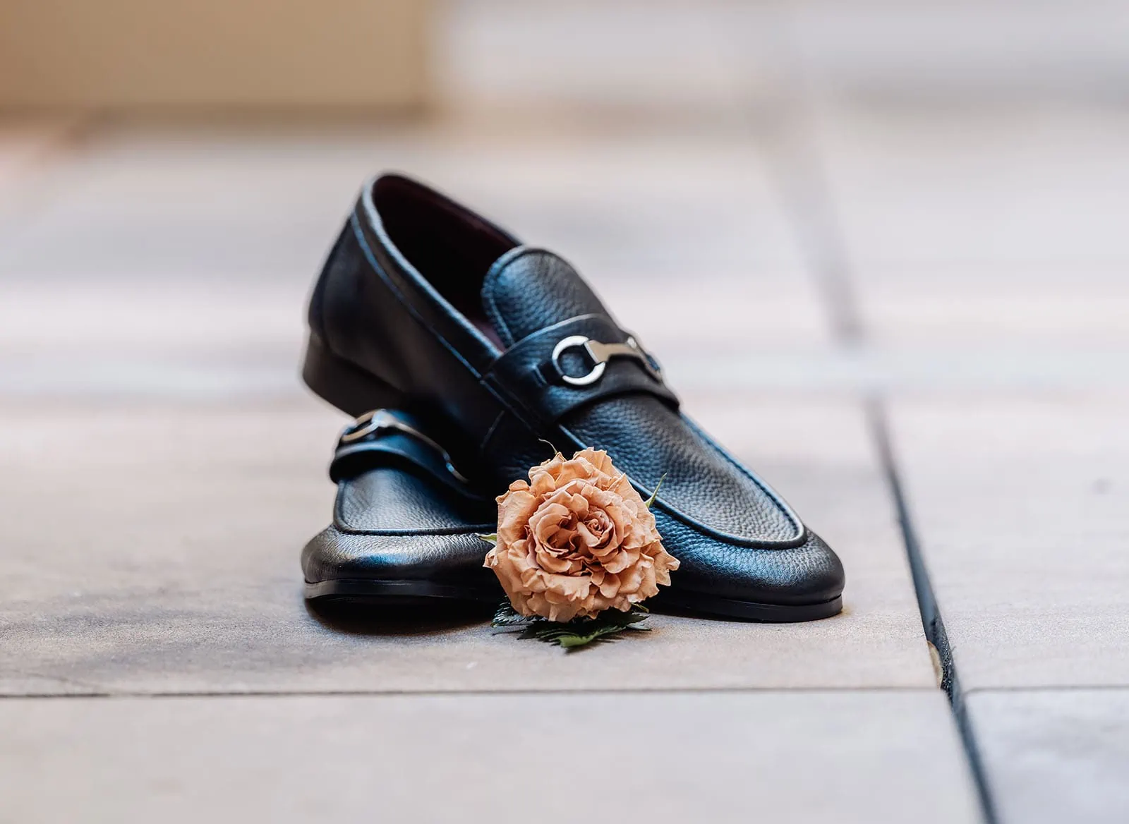 botanic gardens, araucaria avenue wedding - jade & hazim 2 Mens black leather loafers with stylish metal buckle and dried rose accent.