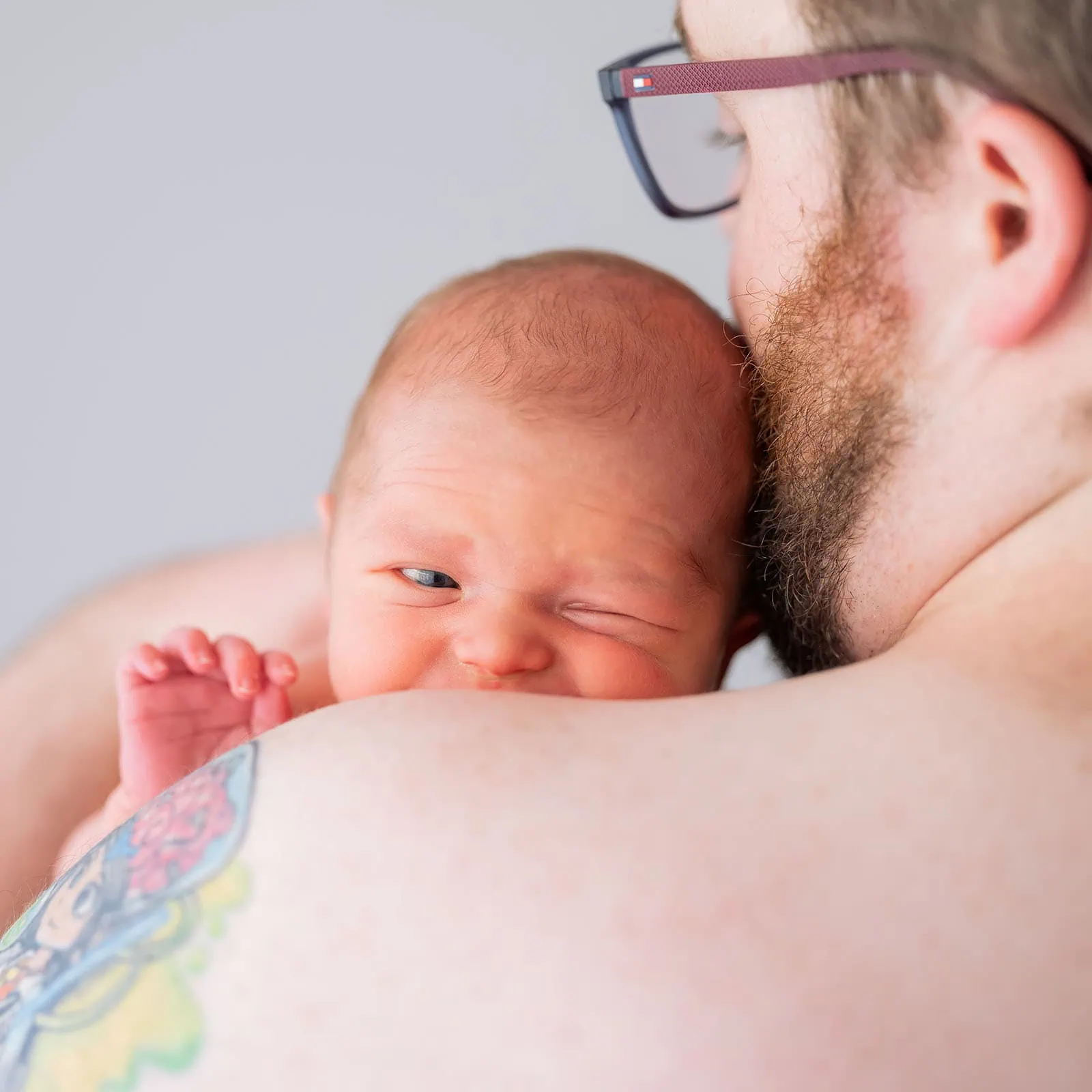 baby spencer's newborn shoot 75 Father lovingly cradling newborn baby, highlighting intimate family moment.