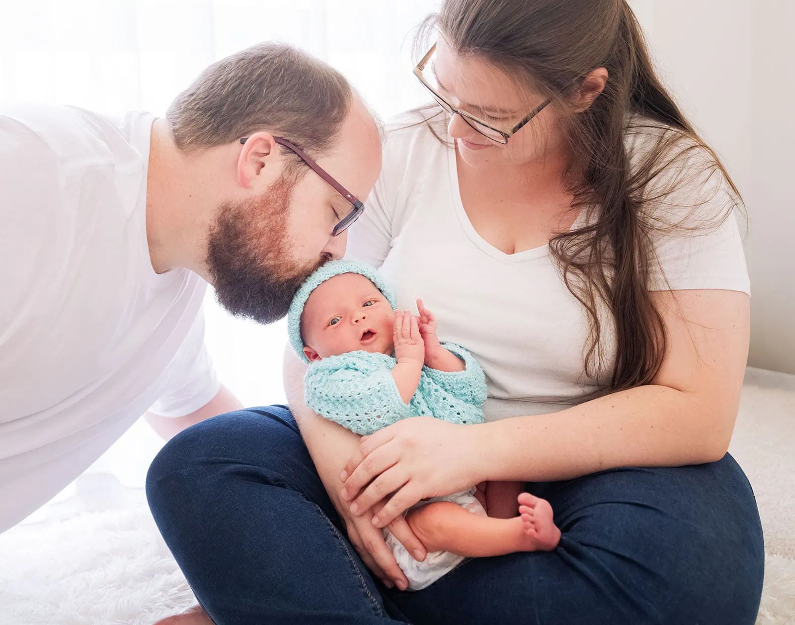 baby spencer's newborn shoot 77 New parents adoring their calm newborn in a warm, light-filled room.