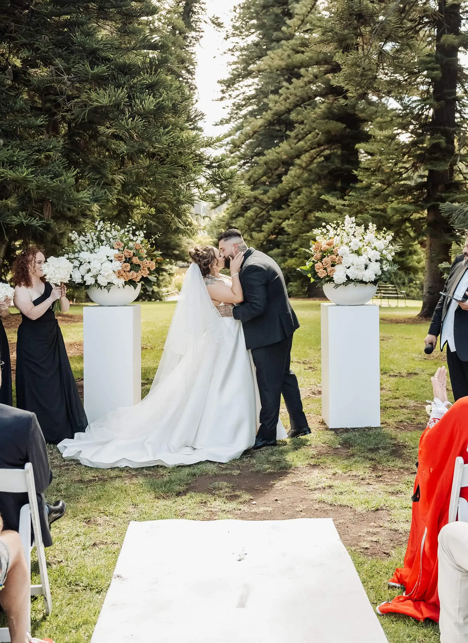 botanic gardens, araucaria avenue wedding - jade & hazim 38 Couple sharing first kiss at intimate garden wedding ceremony.