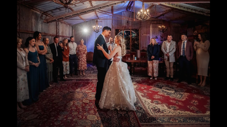 Aldinga Secret Garden wedding couple sharing their first dance in rustic barn setting.