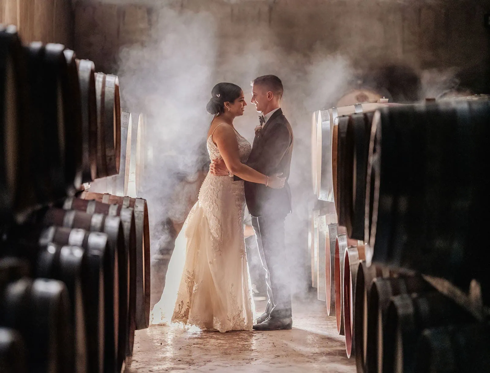 the lane vineyard 9 Bride and groom embrace in atmospheric wine cellar wedding.