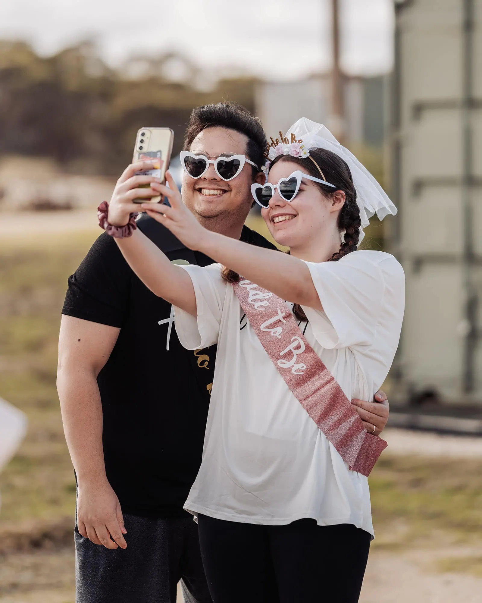 monarto delta force bucks vs hens paintball party 2 Bride-to-be celebration selfie with heart-shaped sunglasses outdoors.
